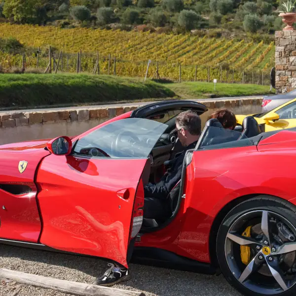 Ferrari supercars in a Tuscan landscape during a guided tour